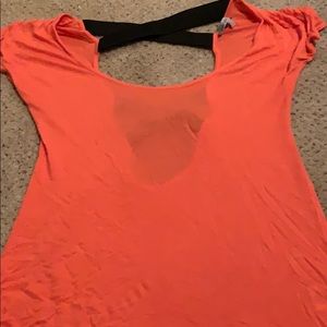 Peach colored top with black straps